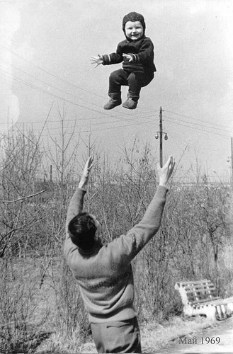 A fitness-minded dad flies a child in the air.