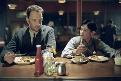 Two best friends sitting at a table eating food.