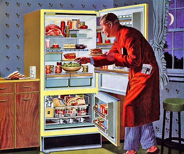 Man in robe having midnight snack. 