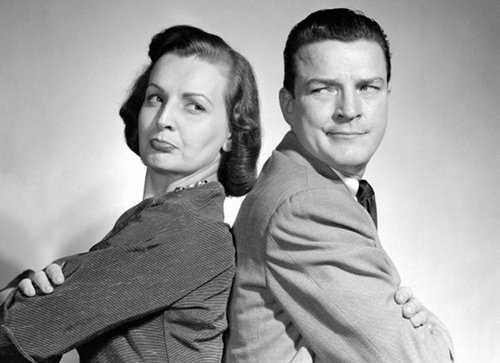 Vintage couple standing with back grumpy look portrait. 